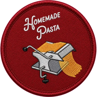 Embroidered Kitchen patch — a hand-crank pasta machine with golden noodles on brick red